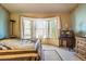 Bedroom with bay window, dresser and TV stand at 6751 N 77Th Dr, Glendale, AZ 85303