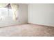 Spacious bedroom with neutral carpeting and large window at 6751 N 77Th Dr, Glendale, AZ 85303