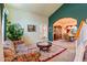 Living room features floral couch, coffee table, and view into dining area at 6751 N 77Th Dr, Glendale, AZ 85303