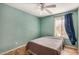 Bedroom with ceiling fan and gray bedding at 6810 W Vermont Ave, Glendale, AZ 85303