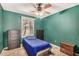 Bedroom with ceiling fan and blue bedding at 6810 W Vermont Ave, Glendale, AZ 85303