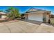 Front view of a brick house with a white garage door at 6810 W Vermont Ave, Glendale, AZ 85303