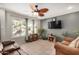 Living room with tiled floors, brown couch, and ceiling fan at 6810 W Vermont Ave, Glendale, AZ 85303