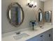 Modern bathroom with double vanity and large mirrors at 7045 W Ocotillo Rd, Glendale, AZ 85303