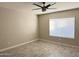 Bright bedroom with ceiling fan and window with blinds at 7045 W Ocotillo Rd, Glendale, AZ 85303