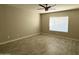 Bright bedroom with ceiling fan and wood-look tile floors at 7045 W Ocotillo Rd, Glendale, AZ 85303