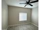 Bright bedroom with ceiling fan and wood-look tile floors at 7045 W Ocotillo Rd, Glendale, AZ 85303