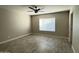 Bright bedroom with ceiling fan and wood-look tile floors at 7045 W Ocotillo Rd, Glendale, AZ 85303