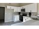 Modern kitchen with white cabinets, stainless steel appliances, and quartz countertops at 7045 W Ocotillo Rd, Glendale, AZ 85303