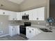 Modern kitchen with white cabinets, stainless steel appliances, and quartz countertops at 7045 W Ocotillo Rd, Glendale, AZ 85303