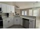 Modern kitchen with white cabinets, stainless steel appliances, and quartz countertops at 7045 W Ocotillo Rd, Glendale, AZ 85303