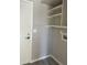 Functional laundry room with shelving and washer/dryer hookups at 7045 W Ocotillo Rd, Glendale, AZ 85303