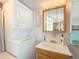 Bright bathroom with vanity, mirror, and stackable washer/dryer at 7750 E Broadway Rd # 123, Mesa, AZ 85208