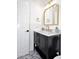 Modern bathroom with dark vanity, marble countertop, and gold accents at 7904 E Pepper Tree Ln, Scottsdale, AZ 85250