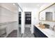 Elegant bathroom with dark vanity, marble countertop, and patterned tile floor at 7904 E Pepper Tree Ln, Scottsdale, AZ 85250