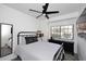 Bright bedroom with a metal bed frame, dresser, and ceiling fan at 7904 E Pepper Tree Ln, Scottsdale, AZ 85250