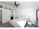 Main bedroom with king bed, ceiling fan, and ensuite bathroom access at 7904 E Pepper Tree Ln, Scottsdale, AZ 85250