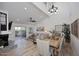 Bright dining room with a large wooden table and hardwood floors at 7904 E Pepper Tree Ln, Scottsdale, AZ 85250