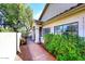 Attractive entryway with a walkway, wooden bench, and lush landscaping at 7904 E Pepper Tree Ln, Scottsdale, AZ 85250