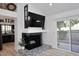 Modern fireplace with a dark mantel and patterned tile surround at 7904 E Pepper Tree Ln, Scottsdale, AZ 85250