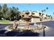 Community entrance with a beautiful fountain and landscaping at 7904 E Pepper Tree Ln, Scottsdale, AZ 85250