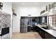 Stylish kitchen featuring dark cabinets, stainless steel appliances, and quartz countertops at 7904 E Pepper Tree Ln, Scottsdale, AZ 85250