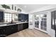 Modern kitchen with dark cabinetry, stainless steel appliances, and a breakfast bar at 7904 E Pepper Tree Ln, Scottsdale, AZ 85250