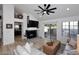 Living room with a fireplace, light gray sofa and hardwood floors at 7904 E Pepper Tree Ln, Scottsdale, AZ 85250