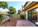 Small patio with red rock landscaping and access to the interior of the home at 7904 E Pepper Tree Ln, Scottsdale, AZ 85250