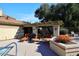 Community patio with shaded seating and lounge chairs at 7904 E Pepper Tree Ln, Scottsdale, AZ 85250