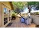 Inviting patio with a dining table and chairs, surrounded by mature trees at 7904 E Pepper Tree Ln, Scottsdale, AZ 85250