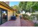 Private patio with tile flooring, mature trees, and space for outdoor furniture at 7904 E Pepper Tree Ln, Scottsdale, AZ 85250