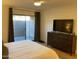 Main bedroom with a king-size bed and access to a private patio at 7950 E Starlight Way # 142, Scottsdale, AZ 85250