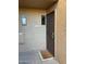 Condo entrance with a brown metal door and welcome mat at 7950 E Starlight Way # 142, Scottsdale, AZ 85250