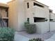 Tan stucco condo building with stairs and walkway at 7950 E Starlight Way # 142, Scottsdale, AZ 85250