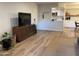 Living room with wood-look floors, and a view into the kitchen at 7950 E Starlight Way # 142, Scottsdale, AZ 85250