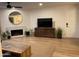 Bright living room featuring a fireplace and wood-look flooring at 7950 E Starlight Way # 142, Scottsdale, AZ 85250