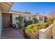 Front entrance of the home with a walkway and lush green bushes at 8119 E San Miguel Ave, Scottsdale, AZ 85250