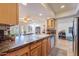 Open kitchen features tile countertops, wood cabinets, and views to the Gathering room at 8119 E San Miguel Ave, Scottsdale, AZ 85250