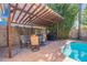 Covered patio with seating and a built-in grill near pool at 8119 E San Miguel Ave, Scottsdale, AZ 85250