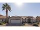 Single-story home with a two-car garage and desert landscaping at 831 E Spanish Moss Ln, Phoenix, AZ 85022