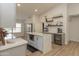 Modern kitchen with gray cabinets, white quartz countertops, and breakfast bar at 831 E Spanish Moss Ln, Phoenix, AZ 85022