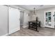 Small dining area with industrial-style table and sliding barn door at 8431 E Stella Ln, Scottsdale, AZ 85250