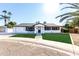 Charming mid-century home features a manicured lawn and updated facade at 8431 E Stella Ln, Scottsdale, AZ 85250