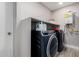 Clean laundry room with washer, dryer, and shelving at 8431 E Stella Ln, Scottsdale, AZ 85250