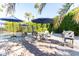 Outdoor patio dining area with umbrella and grill at 8431 E Stella Ln, Scottsdale, AZ 85250