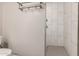 Clean shower with marble-like tile and glass door at 8431 E Stella Ln, Scottsdale, AZ 85250