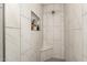 Bright shower with built-in shelf and corner seat at 8431 E Stella Ln, Scottsdale, AZ 85250