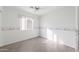 A small, minimally furnished bedroom with light gray tile, white walls, and a border around the room at 8549 E Carol Ave, Mesa, AZ 85208