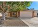 Charming single-story home with a two-car garage, brick accents and mature tree at 8549 E Carol Ave, Mesa, AZ 85208